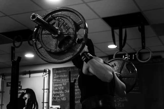 Guy Squatting with barbell